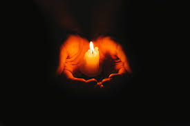 candle in cupped hands